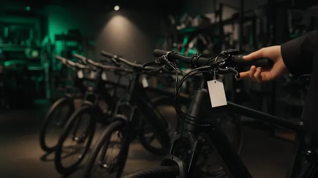 A shopper checking a row of electric bikes with price tags in a bike shop